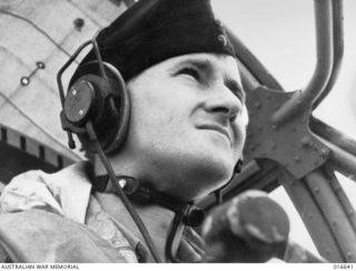 NEW GUINEA. 6 MARCH 1944. A CLOSE-UP OF A WIRELESS OPERATOR. FLIGHT SERGEANT LEE REID OF LEWISHAM DURING A FIGHT OVER NEW BRITAIN. THE WIRELESS OPERATOR KEEPS IN CONSTANT COMMUNICATION WITH THE ..