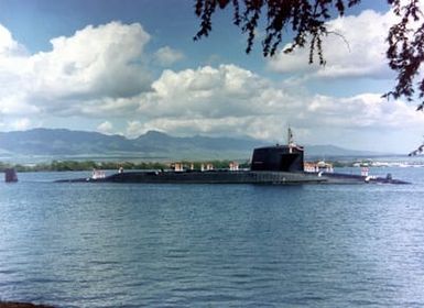 A starboard beam view of the nuclear-powered attack submarine USS SAM HOUSTON (SSN-609) entering the harbor