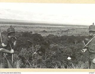 RAMU VALLEY, NEW GUINEA, 1944-02-29. QX43336 SERGEANT J.W. NEIL (1) AND QX43004 PRIVATE L. PEATEY (2), MEMBERS OF THE MORTAR PLATOON, 2/12TH INFANTRY BATTALION, TAKE A SMOKE AND REST AS THEY ..