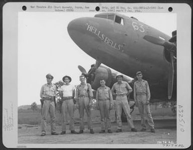 C-47 transport plane, "Hellsbells" and its crew from 6th Troop Carrier Sq., 5th Air Force, Wards Drome, Port Moresby, Papua, New Guinea. Left to right: Capt. Wm. D. Wells, Ovid, N.Y., pilot; Lt. George M. Pearce, Alexandria, La. Co-pilot; T/Sgt. Ward (U.S. Air Force Number 79174AC)