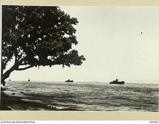 MILNE BAY, NEW GUINEA, 1943-06. AN AMERICAN LANDING CRAFT STANDING OFF THE COAST