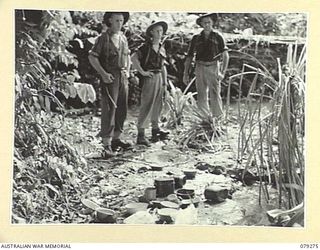 KAMANDRAN, NEW BRITAIN. 1945-02-18. JAPANESE RICE BOWLS SCATTERED ABOUT THE BANK OF A SMALL CREEK NEAR AN ENEMY CAMP WHICH WAS HURRIEDLY EVACUATED WHEN TROOPS OF THE 1ST NEW GUINEA INFANTRY ..