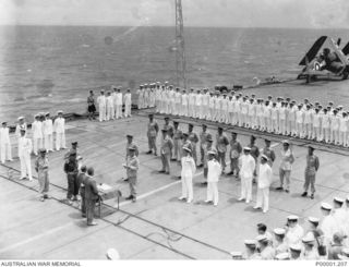 NEW BRITAIN, 1945-09-06. ON BOARD HMS GLORY OFF RABAUL THE OFFICIAL ALLIED PARTY AND MEMBERS OF THE JAPANESE SURRENDER GROUP FACE EACH OTHER ACROSS THE TABLE HOLDING THE SURRENDER DOCUMENTS. ONE OF ..