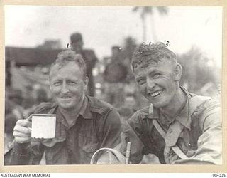SUAIN PLANTATION, NEW GUINEA. 1944-12-06. PRIVATE D.W. LOVELEE, (1), WITH HIS BROTHER PRIVATE J. LOVELEE, (2), FOLLOWING THEIR RETURN FROM AN A COMPANY, 2/4 INFANTRY BATTALION PATROL. THEY ARE TWO ..