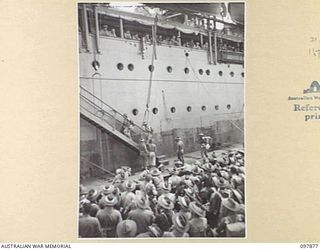 OFF BORAM BEACH, NEW GUINEA. 1945-10-13. THE FIRST BATCH OF TROOPS TO LEAVE THE WEWAK AREA UNDER THE PRIORITY DEMOBILISATION SCHEME WERE MEMBERS OF 6 DIVISION. SHOWN, TROOPS MOVING OFF THE LANDING ..