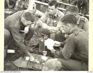 KILIGIA, NEW GUINEA. 1944-04-10. TROOPS AT HEADQUARTERS 5TH DIVISION AREA, PLAYING CARDS WHILE AWAITING COMMENCEMENT OF THE FILM "CHARLEY'S AUNT". IDENTIFIED PERSONNEL ARE:- W38971 SAPPER L.W. ..