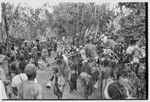 Bride price for Mitsi: group of men from the groom's group dance in the bride's village