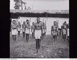 LAE, NEW GUINEA. C.1945. NATIVE POLICE BOYS AT THE FAR EASTERN LIAISON OFFICE HEADQUARTERS