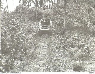 A Sherman tank approaching the rock face at the end of Course no. 1 during tests conducted at HQ 4 Armoured Brigade