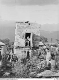 1942-08-28. NEW GUINEA. WAU. ALL THAT WAS LEFT OF THE BANK OF NEW SOUTH WALES AFTER THE JAPANESE BOMBED WAU WAS THE STRONGROOM. NEW GUINEA FORCES RECOVERED SILVER INGOTS WORTH 1,400 POUNDS FROM THE ..