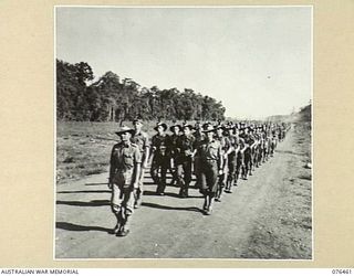 LAE, NEW GUINEA. 1944-10-07. A MARCH PAST OF THE 2/8TH COMMANDO SQUADRON. IDENTIFIED PERSONNEL ARE:- NX68259 LIEUTENANT G.S. PITCHER (1); PX84 LIEUTENANT W.A. GORDON (2); SERGEANT T.J. BANNAH (3); ..