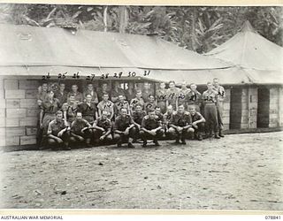 TOROKINA, BOUGAINVILLE ISLAND. 1945-01-30. THE OFFICER IN CHARGE AND THE STAFF OF THE 4TH SUPPLY DEPOT PLATOON IN FRONT OF THE UNIT DETAILS ISSUING DEPOT. FOR IDENTIFICATION OF 31 PERSONNEL SEE ..