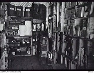 ORO BAY, NEW GUINEA. 1943-04. INTERIOR OF THE DISPENSARY TENT AT THE MEDICAL DRESSING STATION, 10TH FIELD AMBULANCE, ARMY MEDICAL CORPS. NOTE THE USE OF PACKING CASES FOR MAKESHIFT SHELVING AND ..