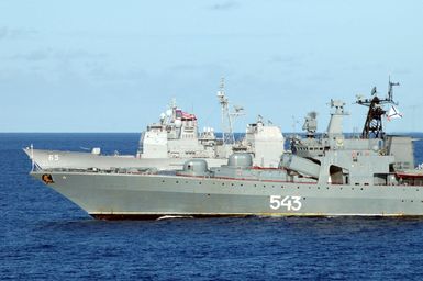 The Russian Federation Navy Udaloy (Fregat) Class (Type 1155) Destroyer MARSHAL SHAPOSHNIKOV (DDG 543) (foreground) and US Navy (USN) Ticonderoga Class Guided Missile Cruiser (Aegis) USS COWPENS (CG 63), underway in the Yellow Sea, during the opening phases of a joint US-Russian Naval Exercise. A Russian Federation Navy vessel made the first visit to the US Territory of Guam in order to participate in a joint humanitarian assistance and disaster relief exercise