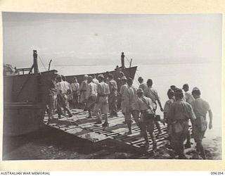 KAIRIRU ISLAND, NEW GUINEA, 1945-09-11. JAPANESE NAVAL PERSONNEL EMBARKING ON BARGES FOR TRANSFER TO MUSCHU ISLAND. AS THE ADVANCE PARTY THEY WILL CONSTRUCT BARRACKS TO RECEIVE THE REMAINDER OF ..