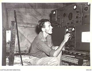 CAPE WOM, WEWAK AREA, NEW GUINEA, 1945-08-14. SIGNALMAN R.W. ADAM, A MEMBER OF 6TH DIVISION SIGNALS, ADJUSTING THE MODULATION OF A TYPE 133 TRANSMITTER THROUGH WHICH MESSAGES PASS FROM HEADQUARTERS ..