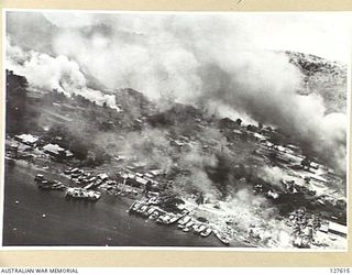 RABAUL, NEW BRITAIN, 1943-11-02. AERIAL PHOTOGRAPH A FEW SECONDS AFTER AN AERIAL ATTACK. BARGES ARE CONCENTRATED ON THE WATER FRONT AS ATTACKING ALLIED AIRCRAFT PASS OUT TO SEA