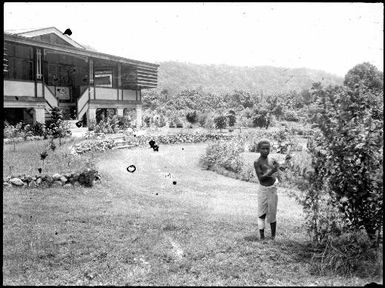 Boy standing in the Chinnery's front garden with the house in the background, Malaguna Road, Rabaul, New Guinea, ca. 1935 / Sarah Chinnery