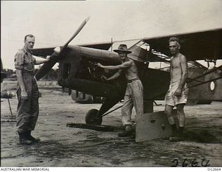 AITAPE, NORTH EAST NEW GUINEA. 1945-05-01. STANDING AS HIGH AS THE AIRCRAFT, LEADING AIRCRAFTMAN (LAC) MERV THOMAS, MAYFIELD, NSW, FLIGHT MECHANIC, IS READY TO GIVE THE LITTLE AUSTER AIRCRAFT'S ..