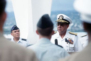 Admiral (ADM) William J. Crowe, commander in chief, US Pacific Command, speaks at a re-enlistment ceremony held on the USS ARIZONA Memorial as US Air Force General (GEN) Jerome O'Malley (left), commander in chief, US Pacific Forces, listens