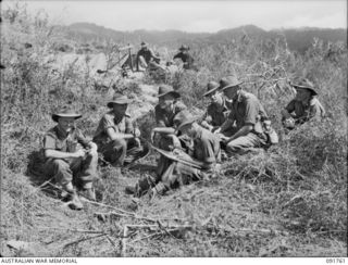 WEWAK, NEW GUINEA. 1945-05-10. MAJOR G.C. CORY, 2/4 ARMOURED REGIMENT WITH OFFICERS OF THE 2/4 INFANTRY BATTALION AT THE COMMAND POST. IDENTIFIED PERSONNEL ARE:- CAPTAIN R.D. BAWDEN, ADJUTANT (3); ..