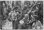 Bride price for Mitsi: women from Tsapinde's (the groom's) group carry large cuts of pork to be shared with bride's group