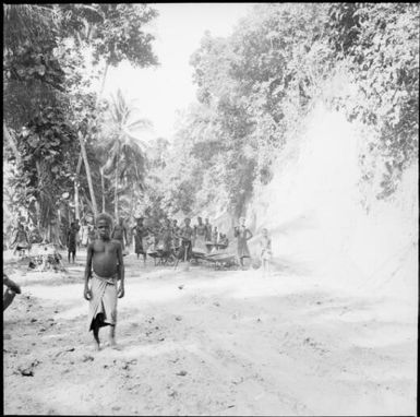 Group of men with shovels and wheelbarrows clearing a road, Rabaul, New Guinea, 1937 / Sarah Chinnery