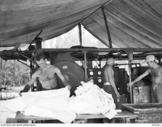 BOUGAINVILLE, 1945-06-18. PERSONNEL WORKING IN THE HOSPITAL LAUNDRY, 109 CASUALTY CLEARING STATION, MOTUPENA POINT. IDENTIFIED PERSONNEL ARE:- L-CPL R. CARTER (1); L-CPL R.V. PRICE (2); PTE R.J. ..