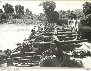 BOUGAINVILLE ISLAND, 1944-11-17. THE 4TH FIELD REGIMENT, GUN PARK SHOWING GUNNERS AND ARTISIFERS DOING MAINTENANCE ON THE UNIT GUNS