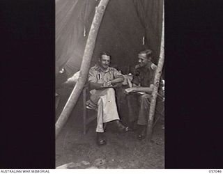 NADZAB AREA, NEW GUINEA. 1943-09-20. VX213 LIEUTENANT COLONEL W. T. ROBERTSON MC, GENERAL STAFF OFFICER 1 (GSO1) (LEFT) AND VX53 MAJOR I. A. LOWEN, GSO2 OF HEADQUARTERS 7TH AUSTRALIAN DIVISION