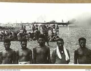 NADZAB, NEW GUINEA. 1943-09-20. NATIVE CARRIERS WHO ARE EMPLOYED BY THE 7TH AUSTRALIAN DIVISION FOR UNLOADING SUPPLIES FROM AIRCRAFT
