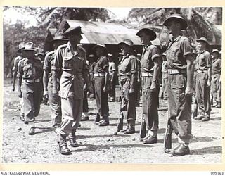 LAE, NEW GUINEA, 1945-12-01. G.H.S. MORAN, INSPECTING TROOPS OF LAE BASE SUB AREA WORKSHOP, CORPS OF AUSTRALIAN ELECTRICAL AND MECHANICAL ENGINEERS, DURING A PARADE HELD ON THE OCCASION OF THE ..