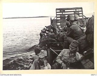 KAIRIRU ISLAND, NEW GUINEA. 1945-09-17. FOLLOWING THE SURRENDER ALL JAPANESE NAVAL PERSONNEL ON KAIRIRU ISLAND WERE TRANSFERRED TO MUSCHU ISLAND. SHOWN BARGE LOAD OF PERSONNEL EN ROUTE. THE ISLANDS ..