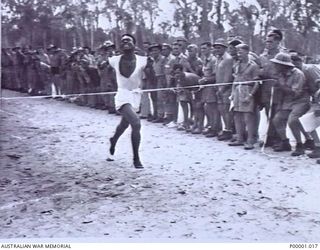 THE SOLOMON ISLANDS, 1945-01-12. A NATIVE COMPETITOR WINNING ONE OF THE FOOT RACES AT A COMBINED ANZAC SPORTS MEETING AT BOUGAINVILLE ISLAND. (RNZAF OFFICIAL PHOTOGRAPH.)