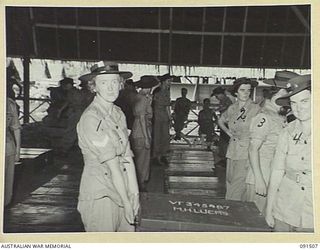 LAE, NEW GUINEA. 1945-05-07. AUSTRALIAN WOMEN'S ARMY SERVICE PERSONNEL CARRYING TRUCKS TO THEIR SLEEPING QUARTERS SHORTLY AFTER ARRIVAL AT THE NEWLY CONSTRUCTED AWAS BARRACKS IN BUTIBUM ROAD. THEY ..