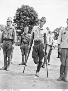 RABAUL, NEW BRITAIN, 1945-11-30. A ONE-LEGGED JAPANESE OFFICER, ONE OF SUSPECTED JAPANESE WAR CRIMINALS LINED UP FOR AN IDENTIFICATION PARADE AT THE CHINESE ARMY CAMP