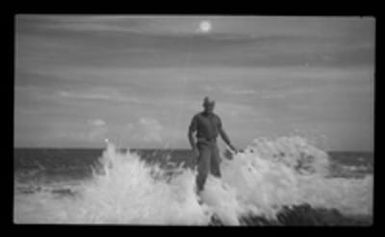 [Elmer A. Ball standing in surf]