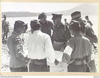 MALAGUNA MISSION, NEW BRITAIN. 1945-09-10. BRIGADIER C.R.V. EDGAR, COMMANDER 4 INFANTRY BRIGADE CONFERRING WITH JAPANESE STAFF OFFICERS ON THE BEACH AFTER THE LANDING OF THE AUSTRALIAN OCCUPATIONAL ..