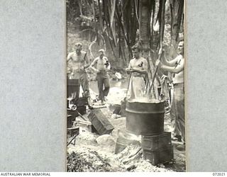 KILIGIA, PAPUA, NEW GUINEA. 1944-04-03. ALLIED SERVICEMEN FROM UNITS LOCATED NEAR THE MOUTH OF THE TUNOM RIVER AND PERSONNEL FROM HEADQUARTERS 5TH DIVISION USE A CUT DOWN FUEL DRUM RESTING ON EMPTY ..