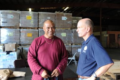 Earthquake ^ Tsunami - Pago Pago, American Samoa, October 10, 2009 -- Deputy Federal Coordinating Officer Gerard Stolar talks to a local employee at this Pago Pago warehouse. The warehouse has served as a primary staging area for local, federal and Federal Emergency Management Agency supplies, as commodities move daily and hourly to recovering communities and families. Dan Stoneking/FEMA