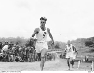 DONADABU, PAPUA, NEW GUINEA. 1944-01-01. VX137507 CORPORAL R. W. LEISHMAN WINNING THE 440 YARDS RACE, WITH VX141668 CORPORAL R. KELLY SECOND, AT THE 15TH INFANTRY BRIGADE GYMKHANA. TIME 64 1/2 ..