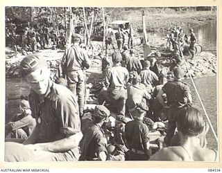 JABA RIVER AREA, BOUGAINVILLE, SOLOMON ISLANDS. 1944-12-18. PRIVATE SLAPE, (1), AND CORPORAL DALL, (2), AMONG D COMPANY, 15 INFANTRY BATTALION TROOPS ABOARD A BARGE RETURNING TO THE RIGHT BANK OF ..