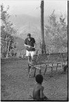 Unidentified white man practicing archery near Cooks' house in Kwiop