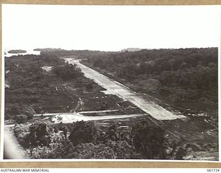 HUON PENINSULA, NEW GUINEA. 1943-12-05. A NEW AIRSTRIP BUILT AT AN ADVANCED POINT IN HEAVILY WOODED COUNTRY ON THE COAST