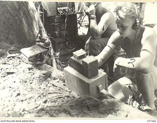 BOUGAINVILLE. 1944-11-24. QX41357 SIGNALLER H. KLEASE, 9TH INFANTRY BATTALION SIGNALS (1) TAKING OVER THE COMMUNICATION CHANNELS FROM 20610512 PRIVATE 1ST CLASS R.W. JOHSNON, 2ND BATTALION, 132ND ..