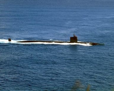 The LOS ANGELES class Attack Submarine USS TUCSON (SSN 770) glides past the mouth of Apra Harbor, Guam. The attack submarine has twelve launch missile tubes for Tomahawk cruise missiles to provide defense capabilities and retractable bow planes to give the vessel increased maneuverability. With it's stealth design, endurance, and mobility the TUCSON is able to operate in all ocean areas of the world. She is the 59th of her class and homeported out of Pearl Harbor, Hawaii