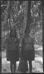 Two women in necklaces and grass skirts