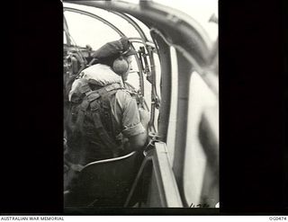 AIRBORNE NEAR LINDENHAFEN, NEW BRITAIN. 1944-01-17. STRIKING DAYLIGHT RAIDS BY BEAUFORT BOMBERS ON NEW BRITAIN TARGETS. "BOMBS GONE" FLYING OFFICER BOB TAYLOR OF BANGALOW, NSW, OBSERVER IN A ..