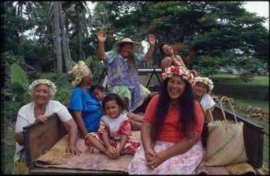 Group sitting on back of ute, Mangaia