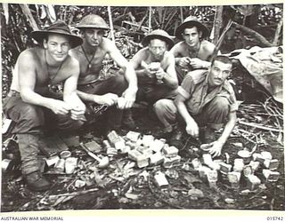 1943-09-20. NEW GUINEA. BUSO RIVER, - LAE AREA. AUSTRALIAN TROOPS OPEN UP TINS OF BULLY BEEF. (NEGATIVE BY H. DICK)